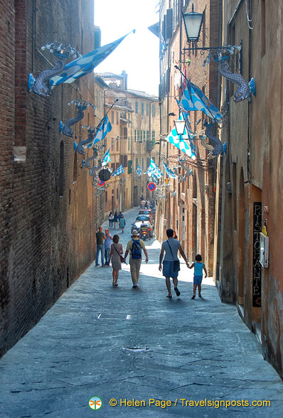 Streets of Siena decorated with flags of Onda who won the July 2012 Palio di Provenzano