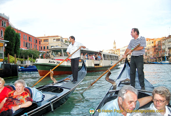 A vaporetto's approaching but the gondoliers are fearless
