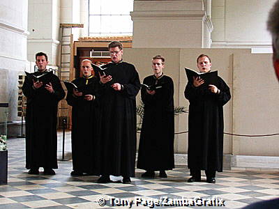 Priests performing for visitors