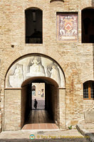 Painting and coat of arms in the Palazzo Comunale courtyard