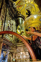 The faithful touching the orb of the Black Madonna