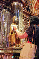 Pilgrims and the faithful come to Montserrat Basilica to touch the wooden orb of the Black Madonna