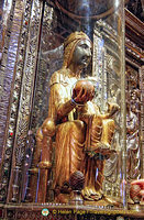 The Black Madonna's wooden orb protrudes through the glass for pilgrims to touch