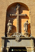 The cross is richly carved with plant motifs