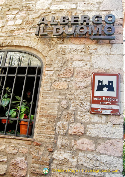 At this Albergo il Duomo sign, take the steps up to the Rocca Maggiore