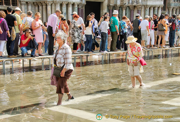 These two elderly ladies don't mind walking in the water