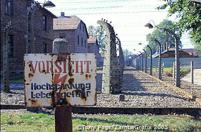 A camp fence sign warning against high voltage