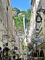 Getreidegasse - a charming narrow shopping strip decorated with wrought iron guild signs 