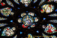 Close-up of the rose window. In the centre is Christ returned to judge the dead and the living