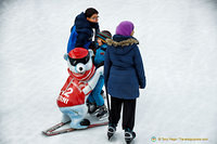 Polar bear helping this kid to ice-skate