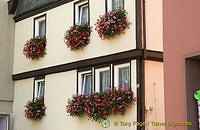 Beautiful flower baskets decorate many of the windows in town