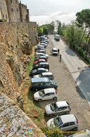 Cars parked outside Pienza historic city walls