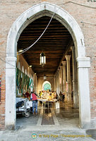View of Mercato del Pesce through an entrance arch