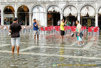Tourists snapping each other in Venice's Acqua Alta