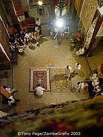 Tourists entertained by a carpet merchant in the Fez medina