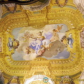 In the center of the ceiling a female figure is recognisable. She is the allegory of Faith