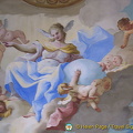 In the center of the ceiling is a female figure. She is the allegory of Faith