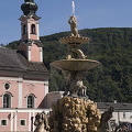 Baroque Residenz fountain with St. Michael's Church in the background