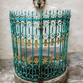 An ancient fountain with a colourful grill