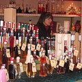 Cologne Weihnachtsmarkt stall selling colorful bottles of liqueur