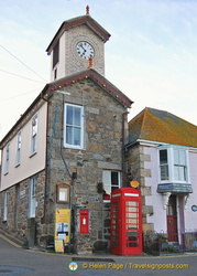 The towering Mousehole harbour office with the Post Office next to it