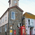 The towering Mousehole harbour office with the Post Office next to it