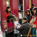 A group of Indian visitors having their caricature sketched