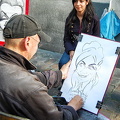 Place du Tertre is known for its artists who paint tourists like this woman