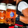The beer mugs are bigger than this girl's arm