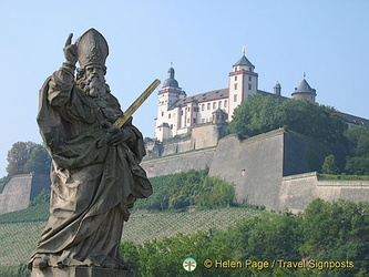 Statue of St Kilian and his golden sword with the Marienberg Fortress in the background