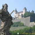 Statue of St Kilian and his golden sword with the Marienberg Fortress in the background