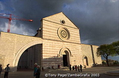 The exterior of the building consists of alternate strips of pink and white stone, with massive supporting arches on either side