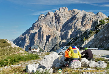 Three travellers checking their bearings on Passo Valparola