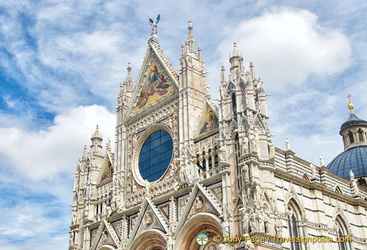 At the top of the west facade is the mosaic depicting the Coronation of the Virgin