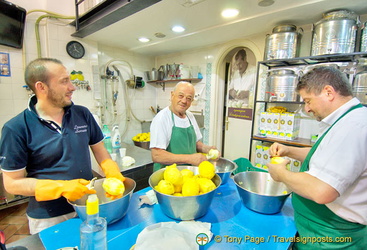 Men (including the boss) peeling lemons at the back of the Limonoro shop