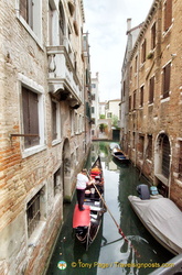A goods carrying gondola in the back canals of Venice