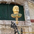The Golden Head can be seen from the Rialto Bridge above shops on the San Marco side
