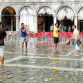 Tourists snapping each other in Venice's Acqua Alta