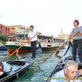 A vaporetto's approaching but the gondoliers are fearless