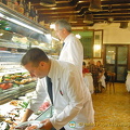 Waiters selecting seafood for orders