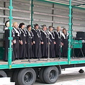 Choral group performing from a mobile stage