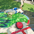 These people were doing sumo-wrestling in the park