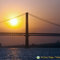 Sunsetting behind the 25th of April Bridge