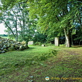 The standing stones are part of the stone circle surrounding the cairn