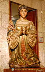 Sacristy Museum: The praying statue of Queen Isabella next to the Passion Altarpiece
