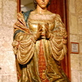 Sacristy Museum: The praying statue of Queen Isabella next to the Passion Altarpiece