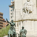 Cervantes with Don Quixote on his horse and Sancho Panza trotting along