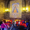 Pilgrims leave candles as offerings to Our Lady on exiting the Niche