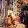 Pilgrims and the faithful come to Montserrat Basilica to touch the wooden orb of the Black Madonna