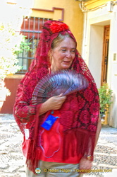 Dressed in the traditional mantilla and Spanish fan